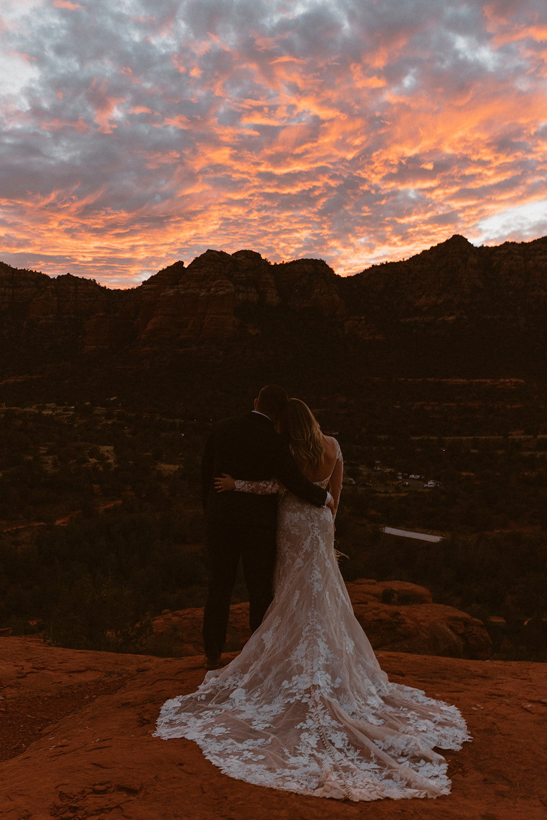 bridal couple looking out into the gorgeous sunset