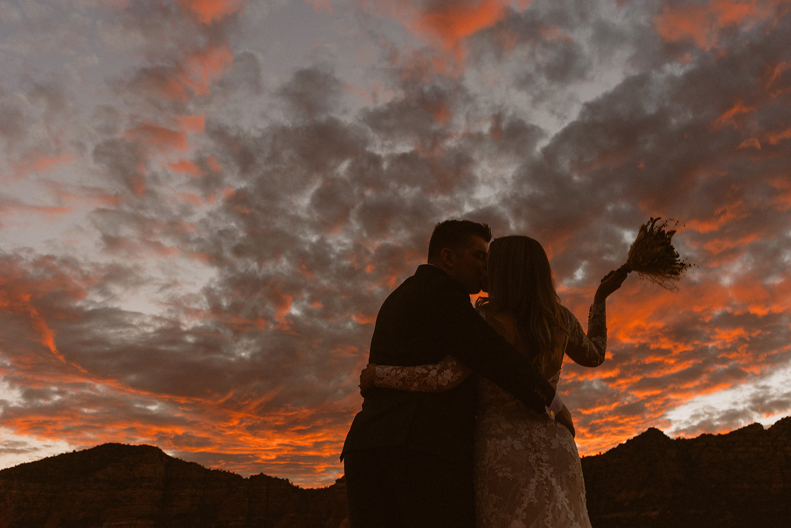 bridal couple kissing during the sunset at sedona elopement wedding 