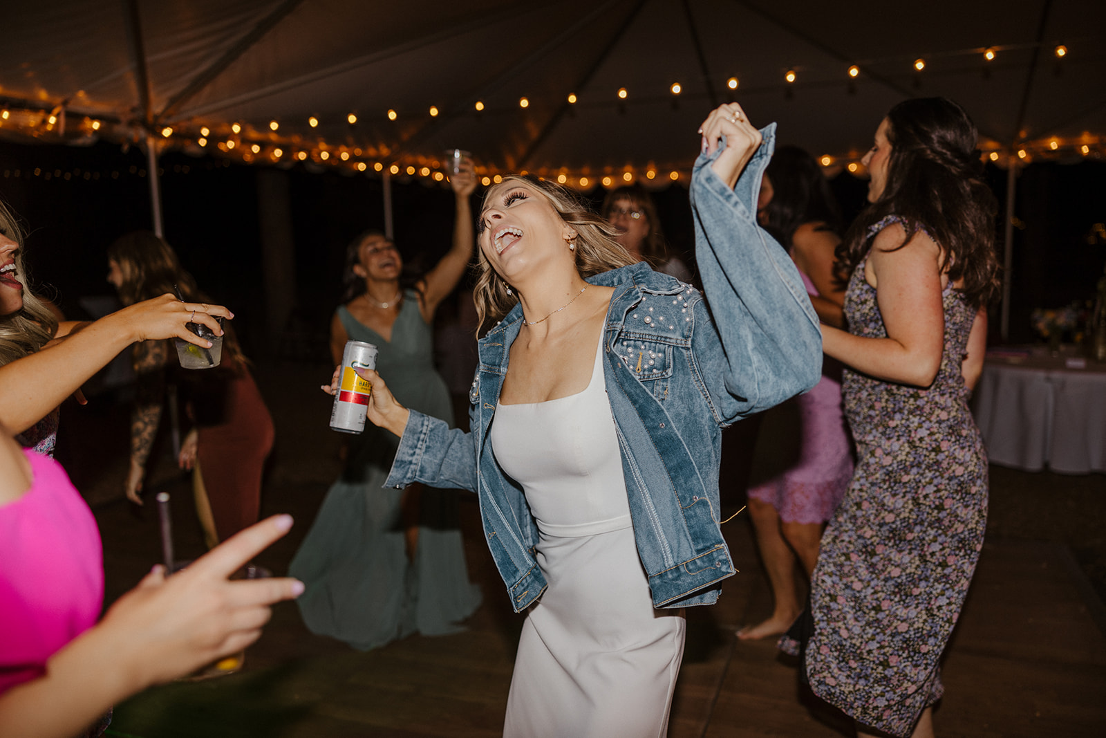 bride dancing and wearing a denim jacket 