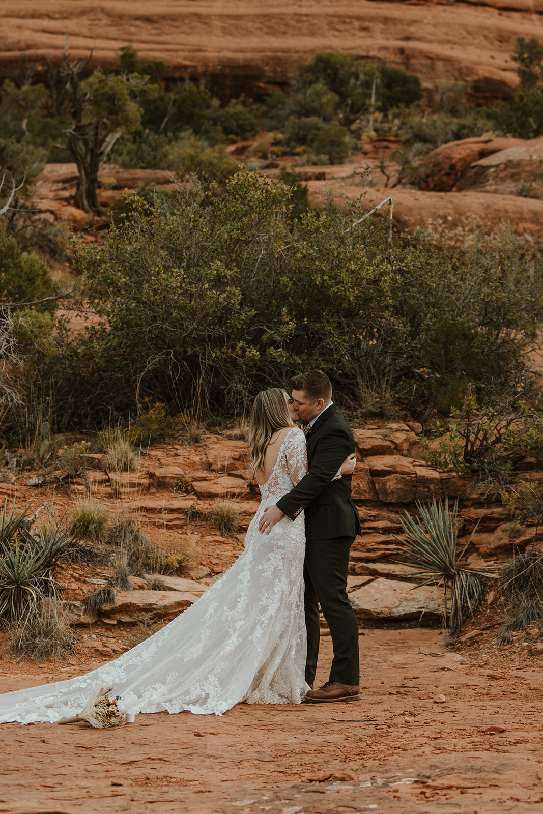 bridal couple kissing at the end of Sedona elopement ceremony 