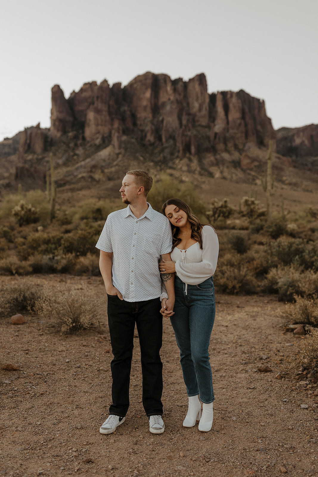 newly engaged couple holding arms at lost dutchman state park az