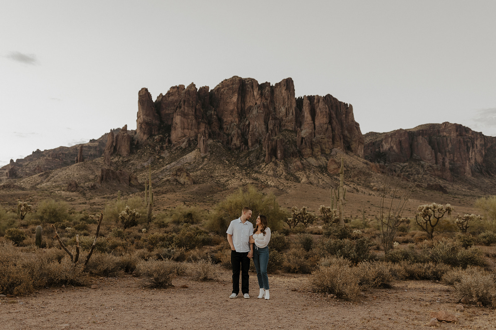 engaged couple holding hands at lost dutchman state park az engagement session