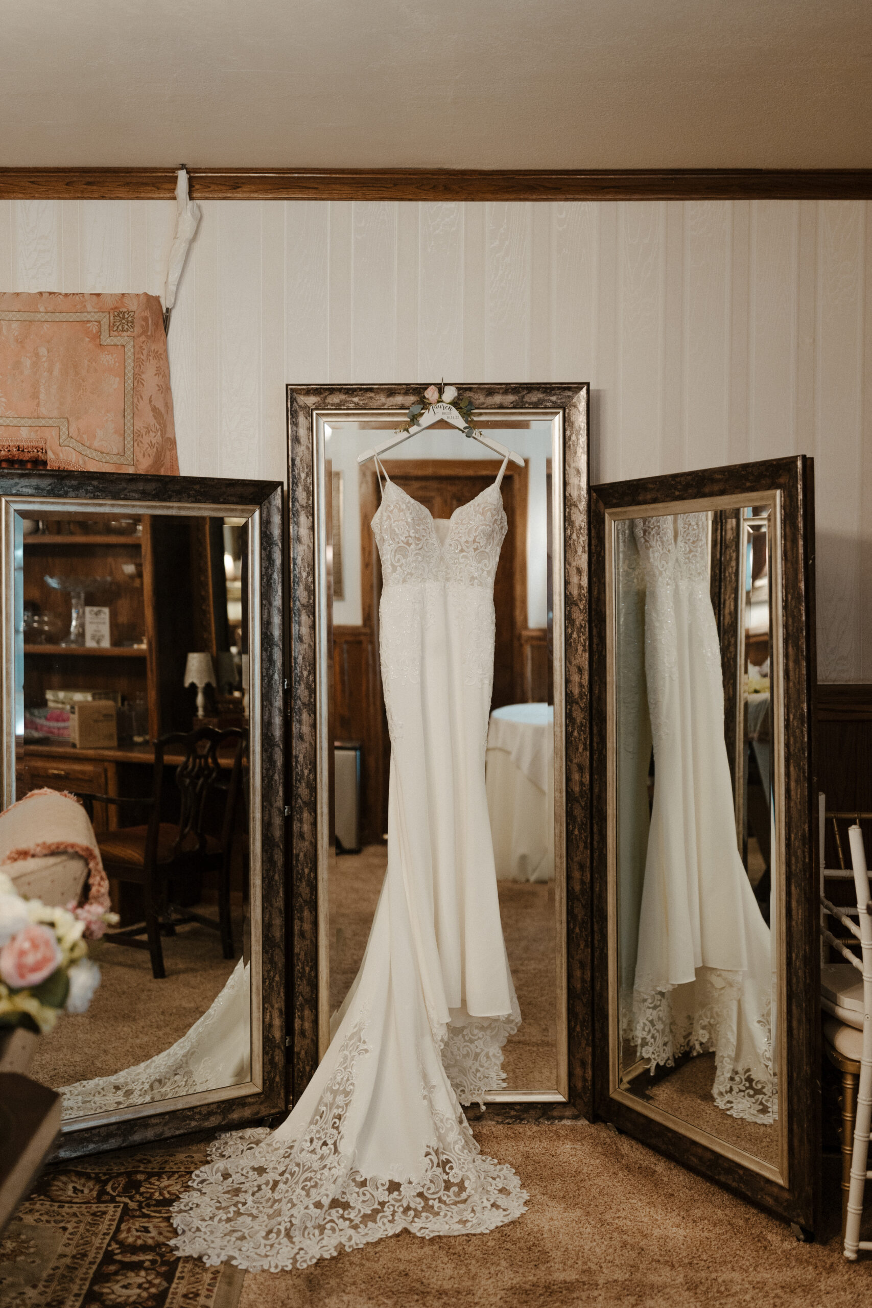 bride's dress hanging on a mirror 