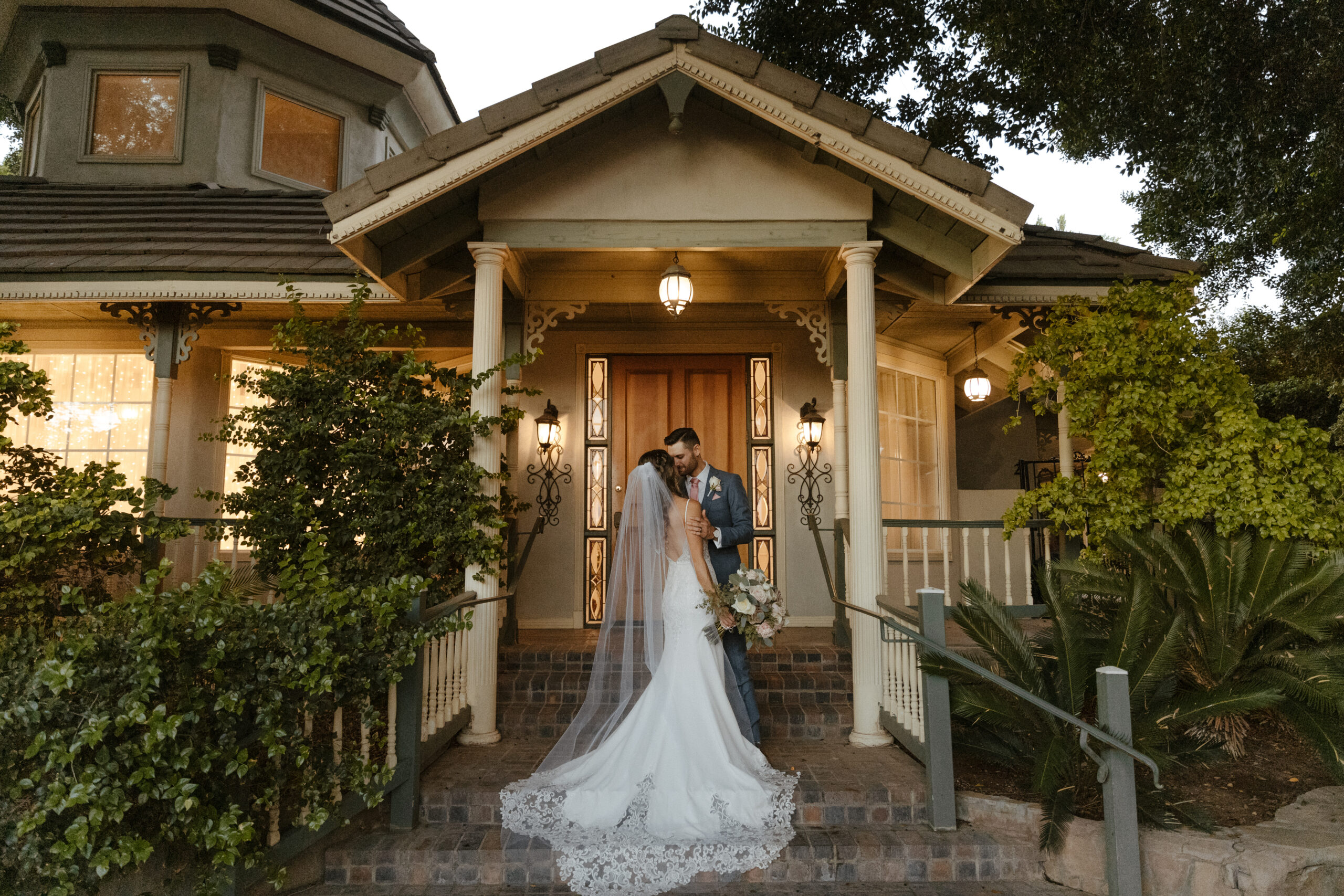 bride and groom portrait in front of vintage house at garden wedding in arizona 