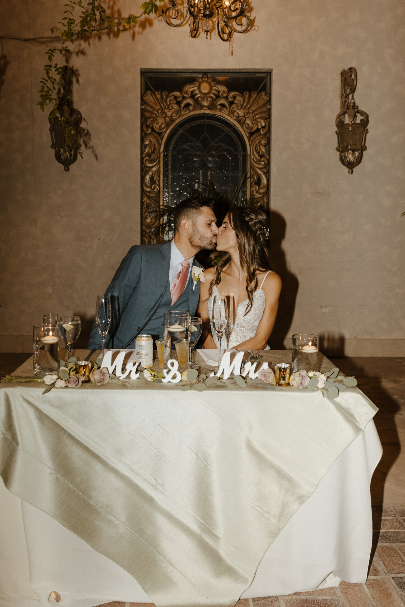 bride and groom kissing at head table  at the wright house 