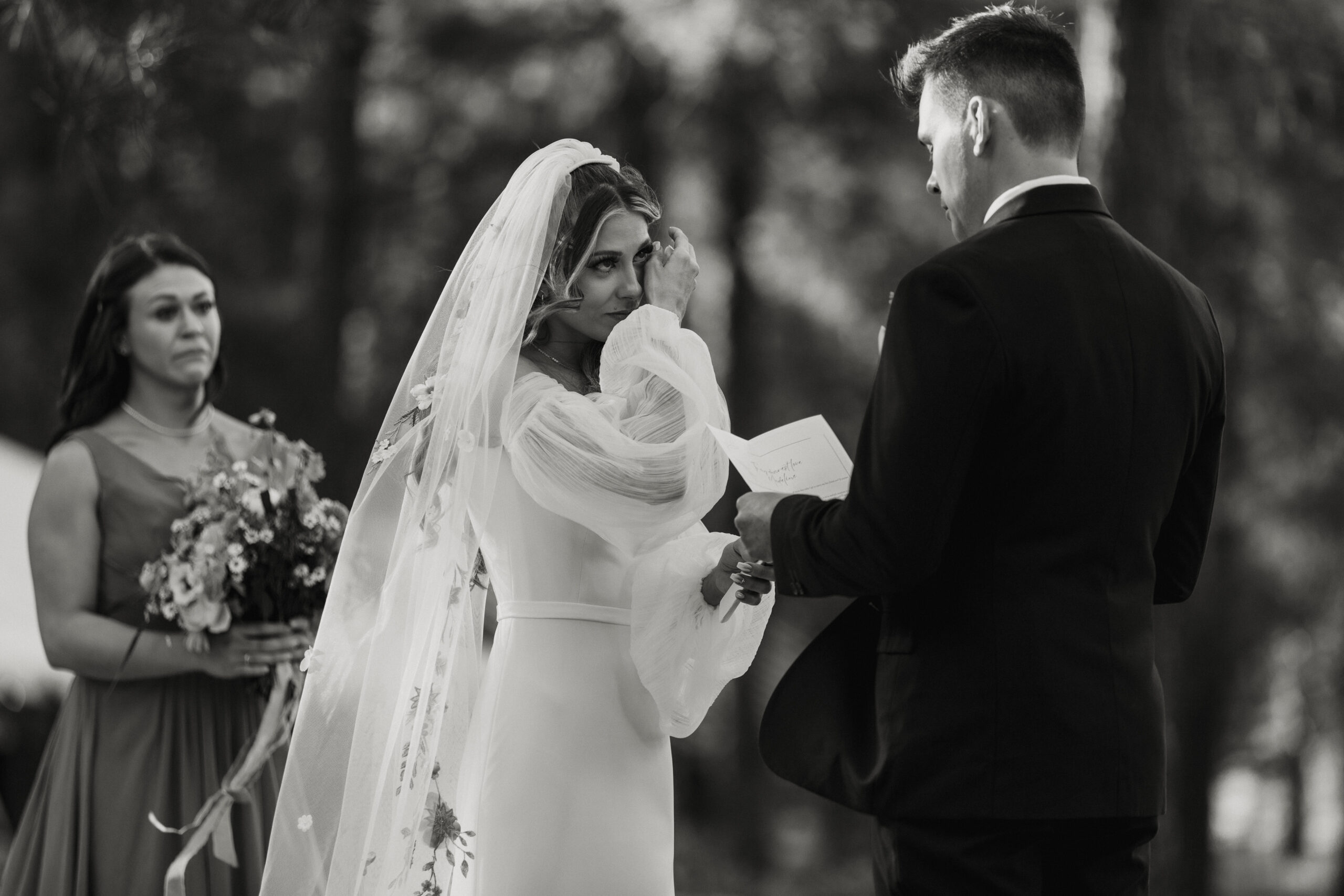 bride getting emotional during intimate forest wedding ceremony 