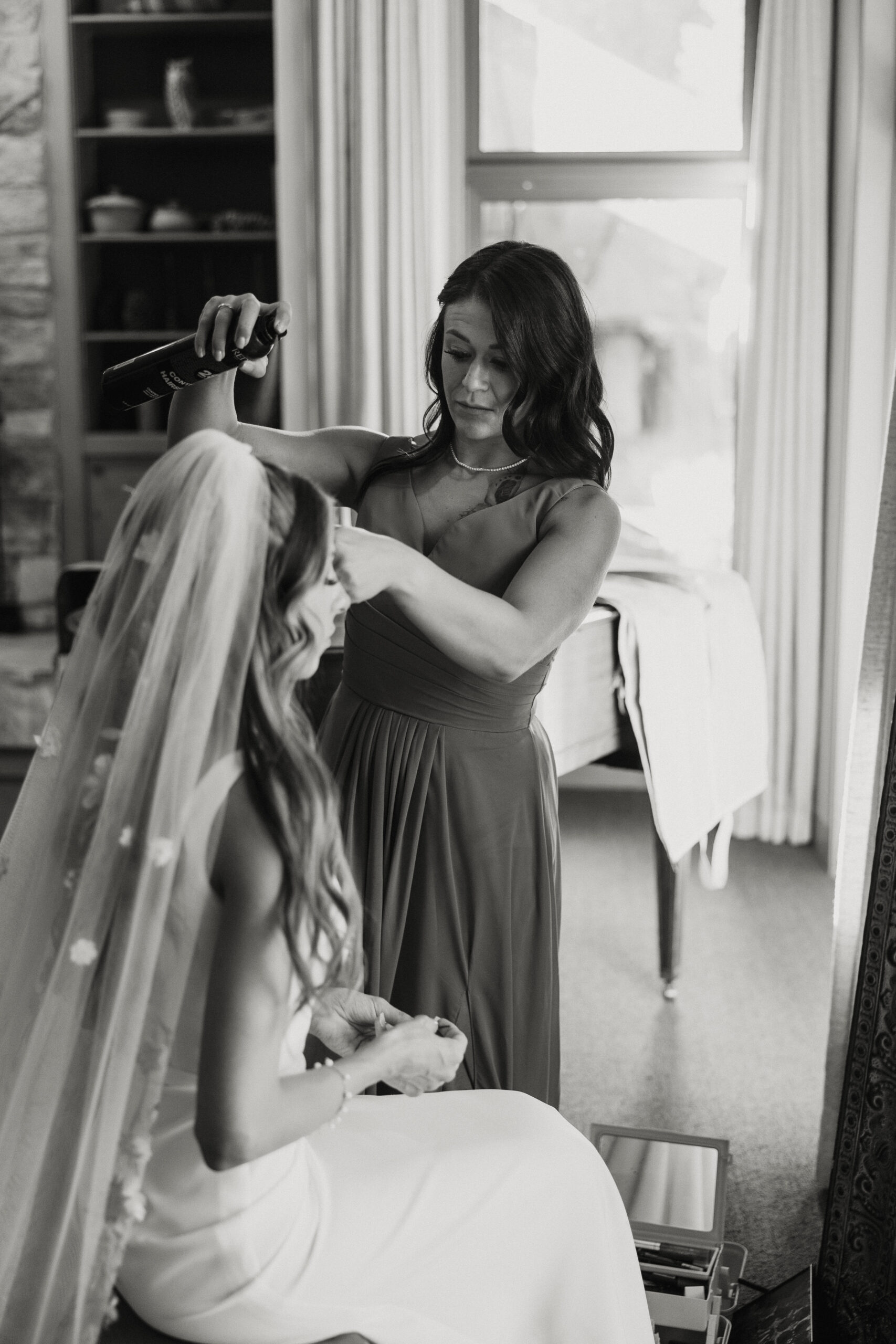 mother of bride helping with her hair 