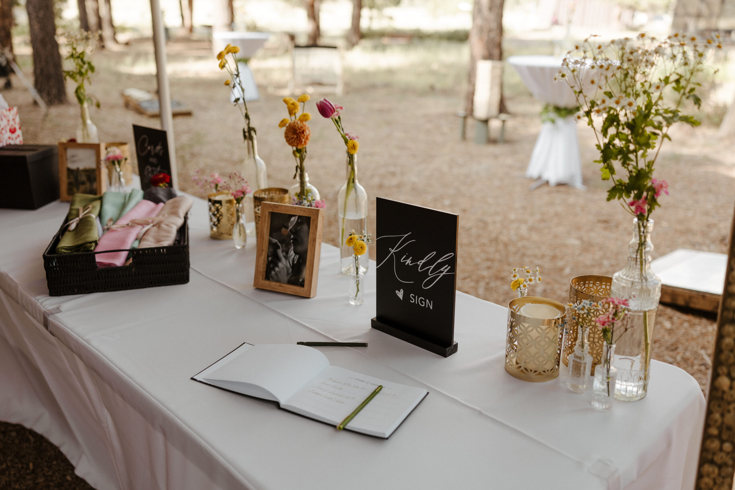 wedding guest book and flowers in vases