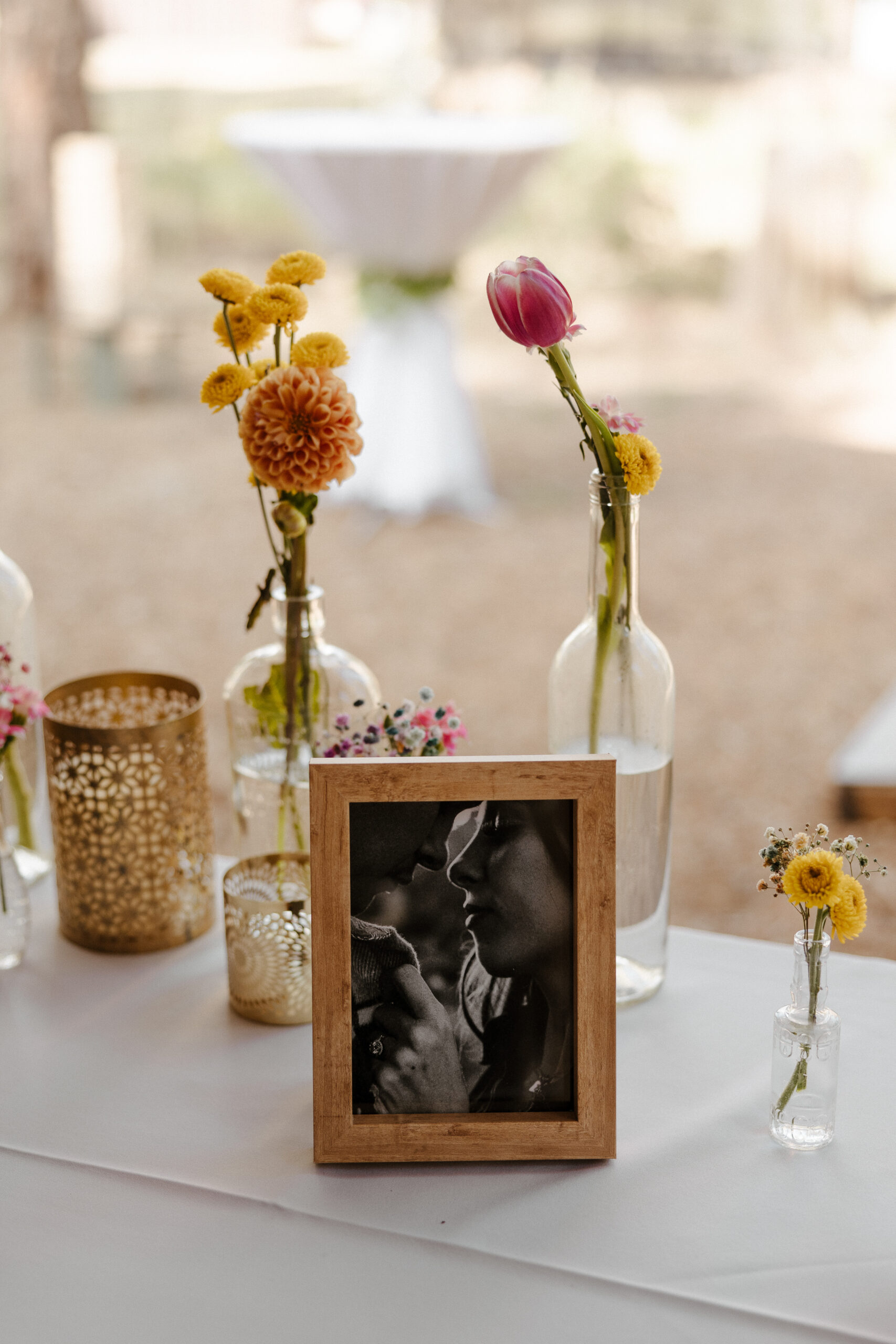 floral decorations and photos of bride and groom at intimate forest wedding 