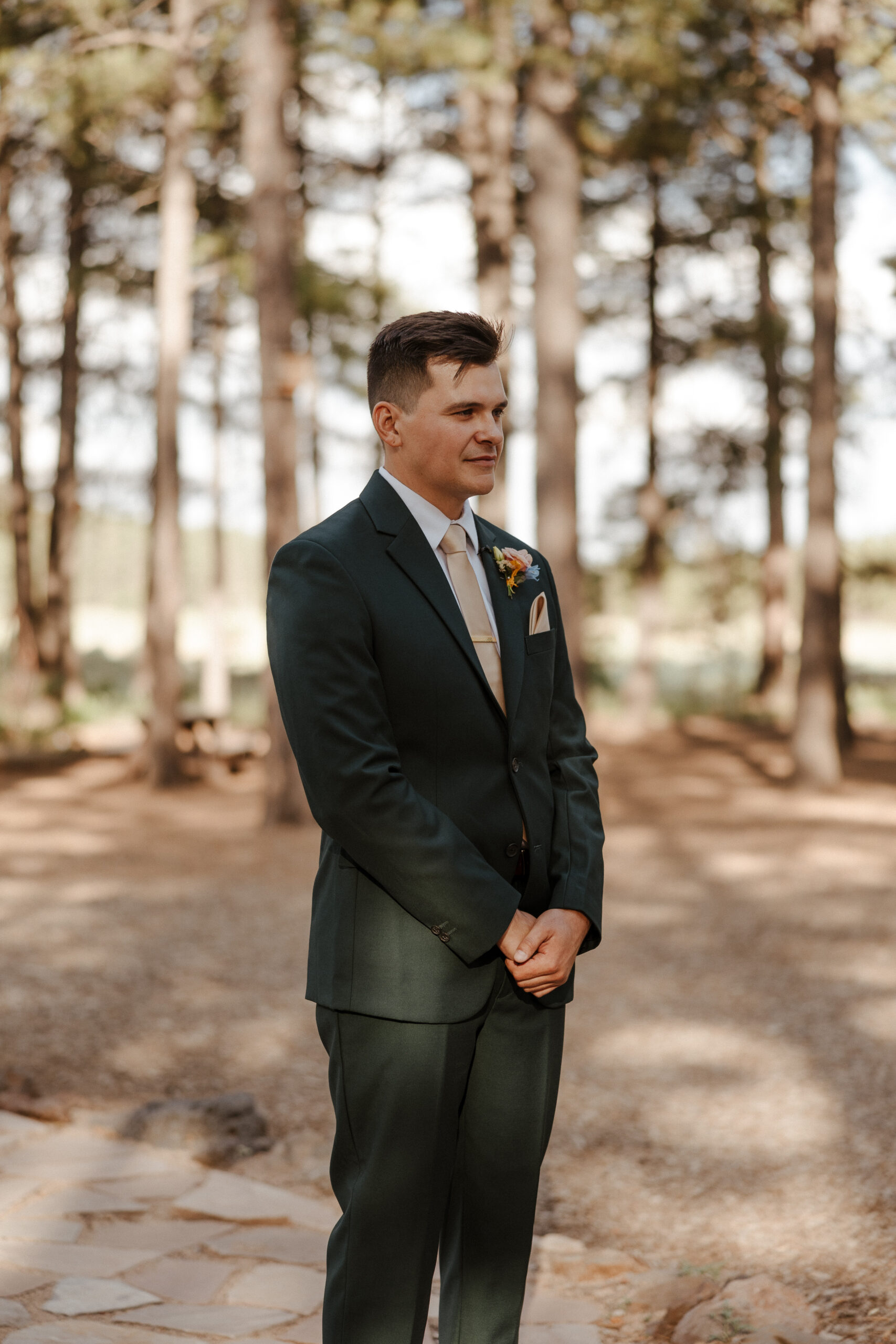 groom as the bride walks down the aisle at intimate forest wedding 