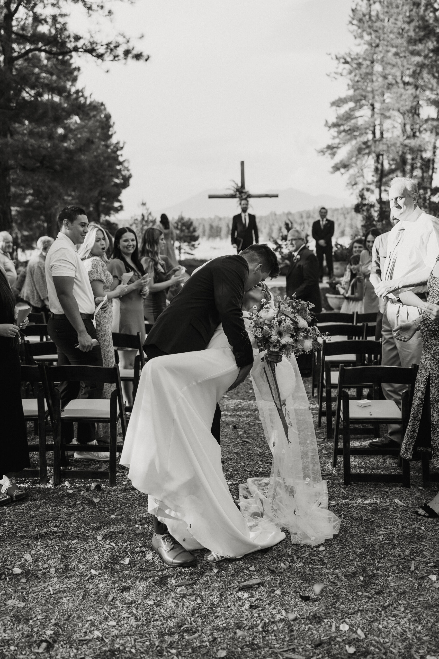 bride and groom kissing after intimate forest wedding ceremony 