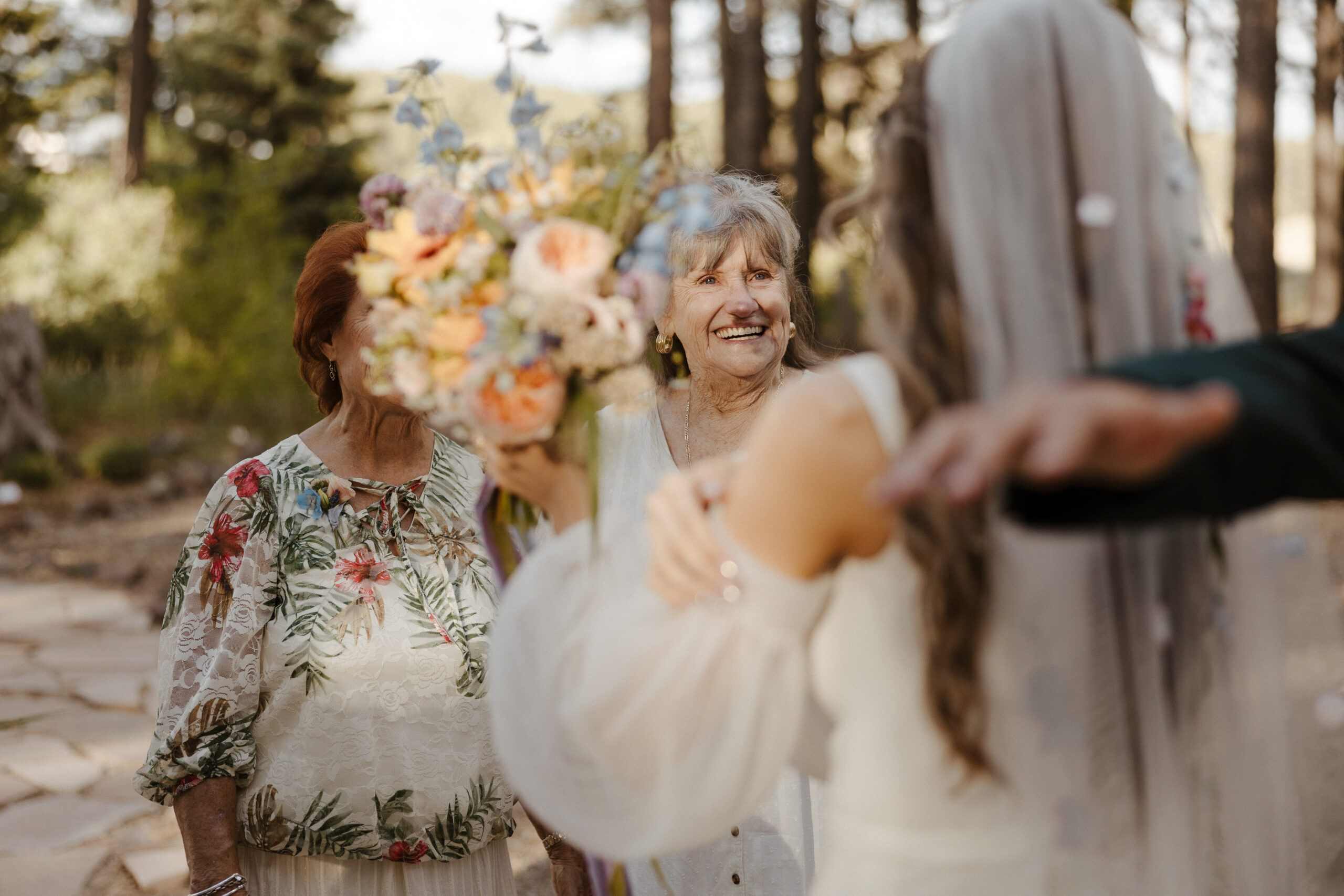 candid of grandmothers smiling at bride