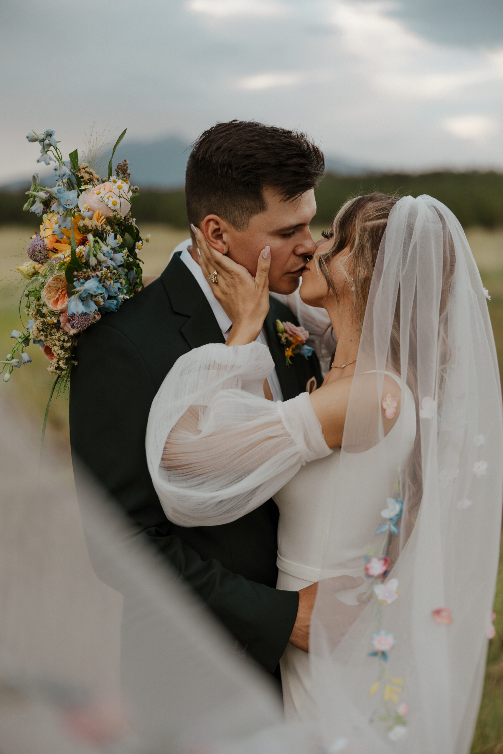bride and groom kissing veil portrait 