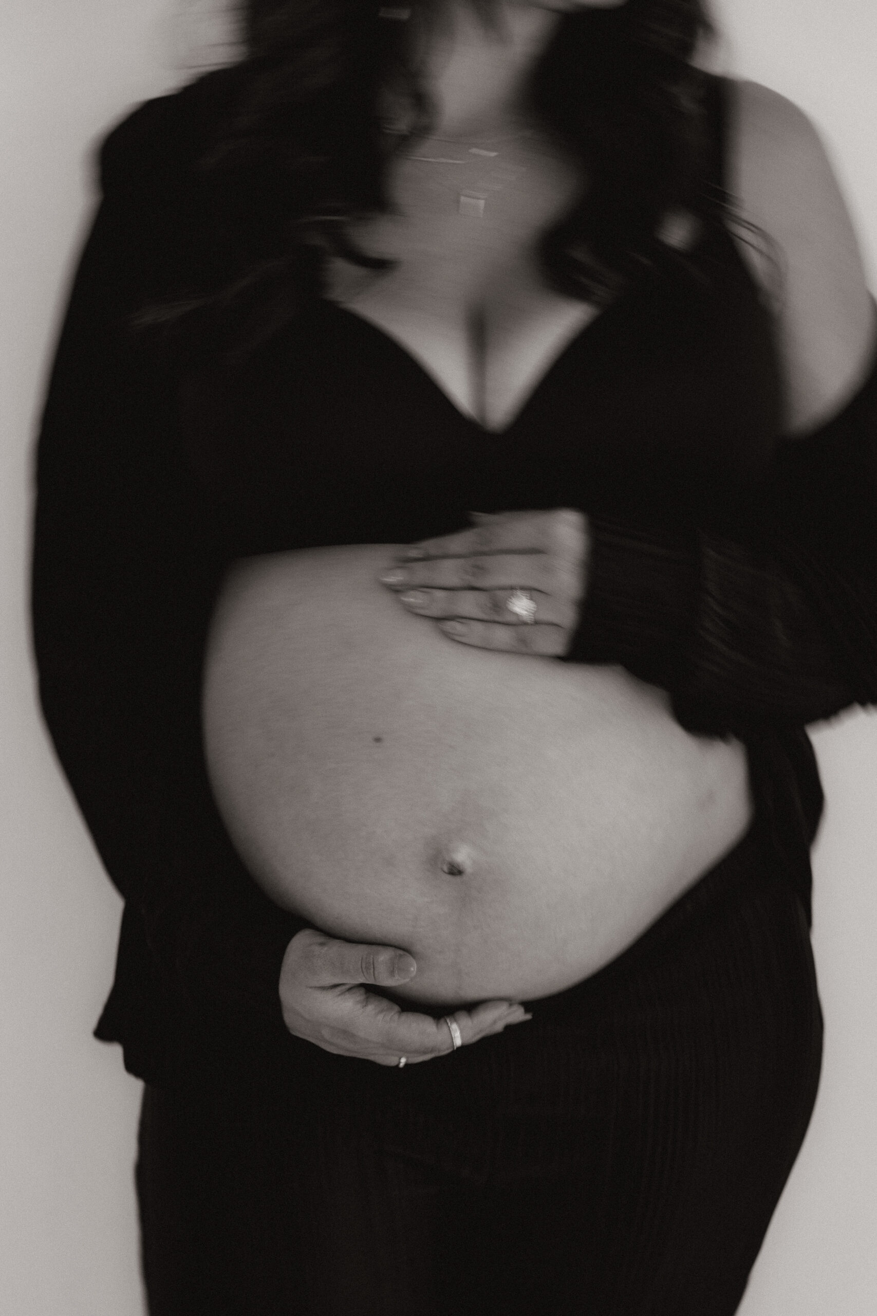 closeup blurry photo of mom to be's pregnant stomach 
