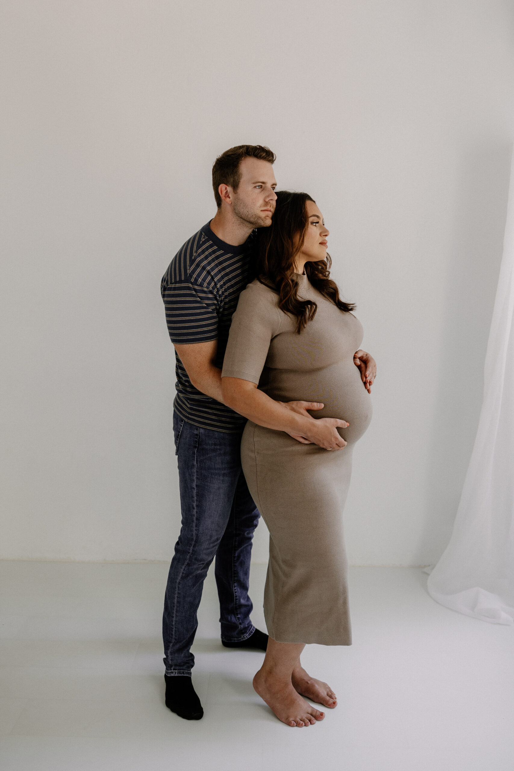 parent to be's during editorial maternity photos facing away from the camera