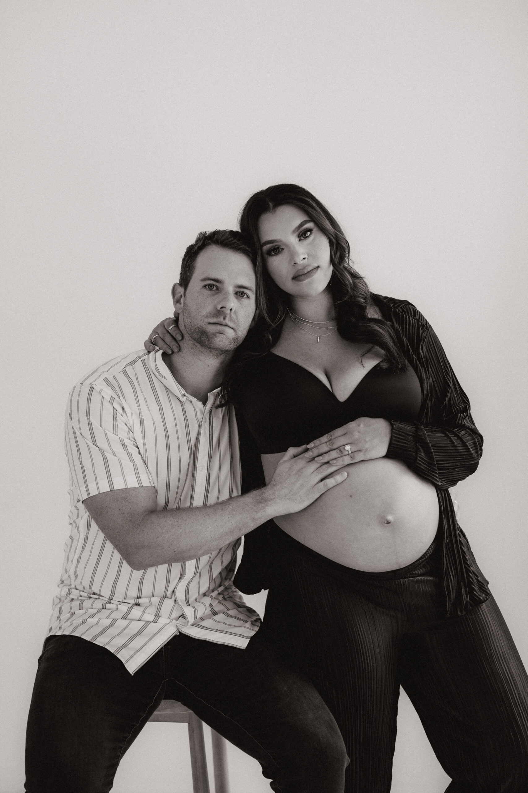 parent to be's looking at the camera with a serious face during their editorial maternity photoshoot