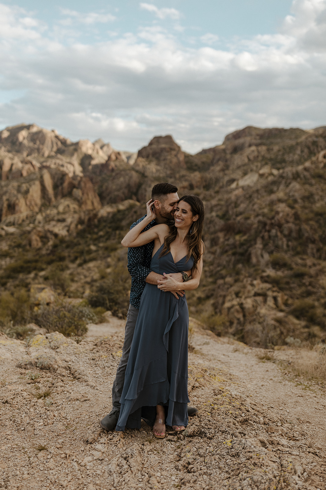fiance holding other fiance from behind during engagement photos