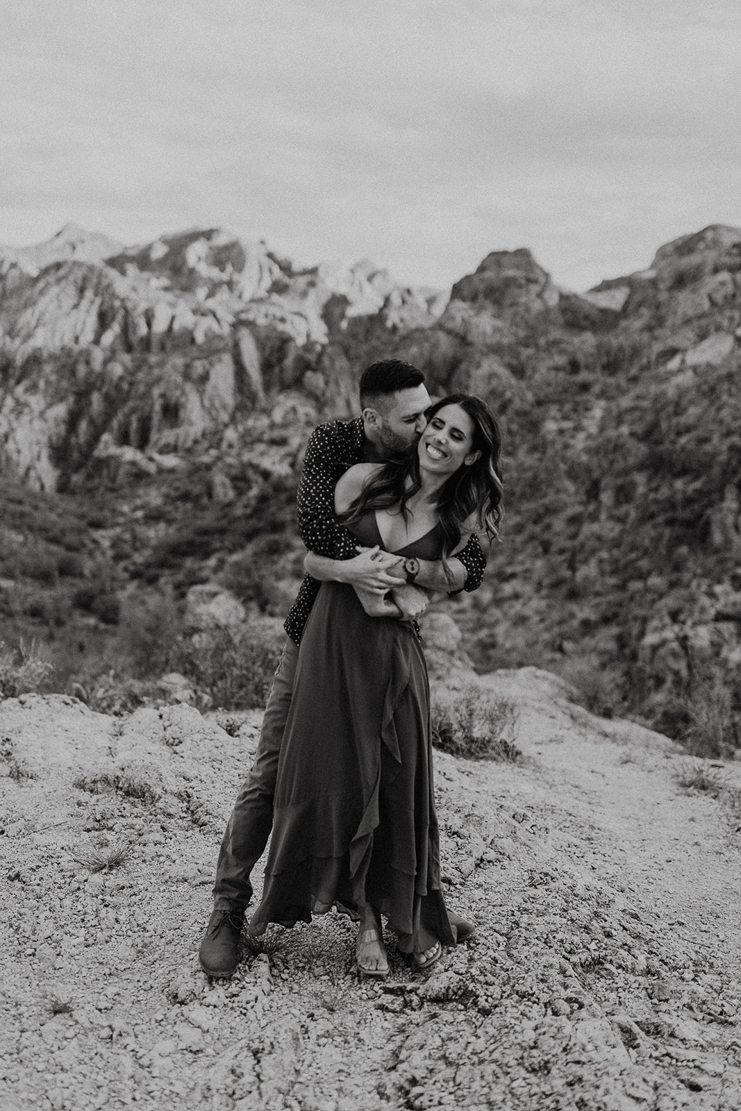 black and white of couple hugging and smiling 