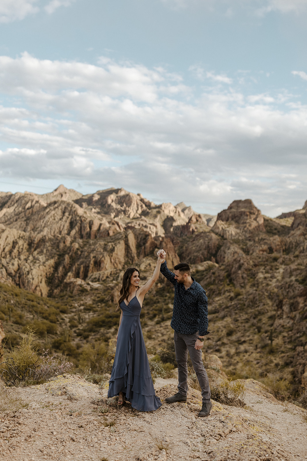 engaged couple dancing in the mountains during canyon lake arizona engagement pictures