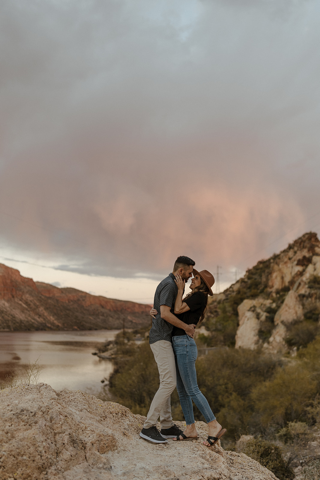 couple kissing by canyon lake during their engagement pictures 