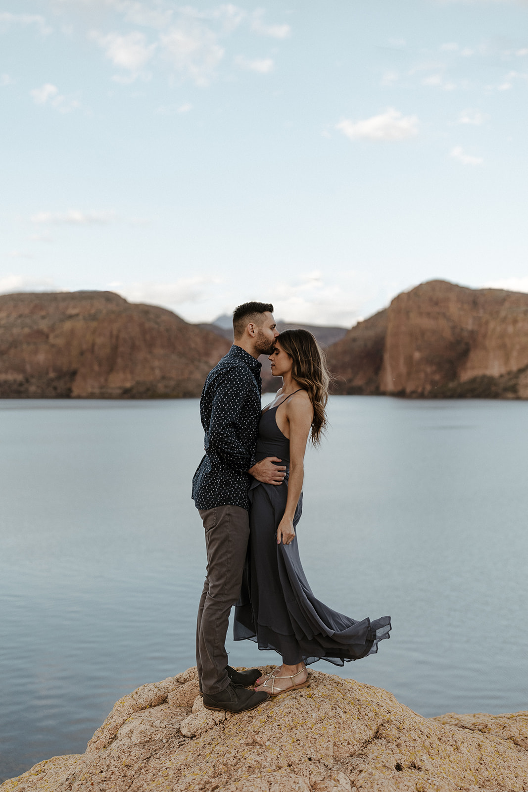 fiance kissing other fiances forehead with the lake background during canyon lake arizona engagement pictures