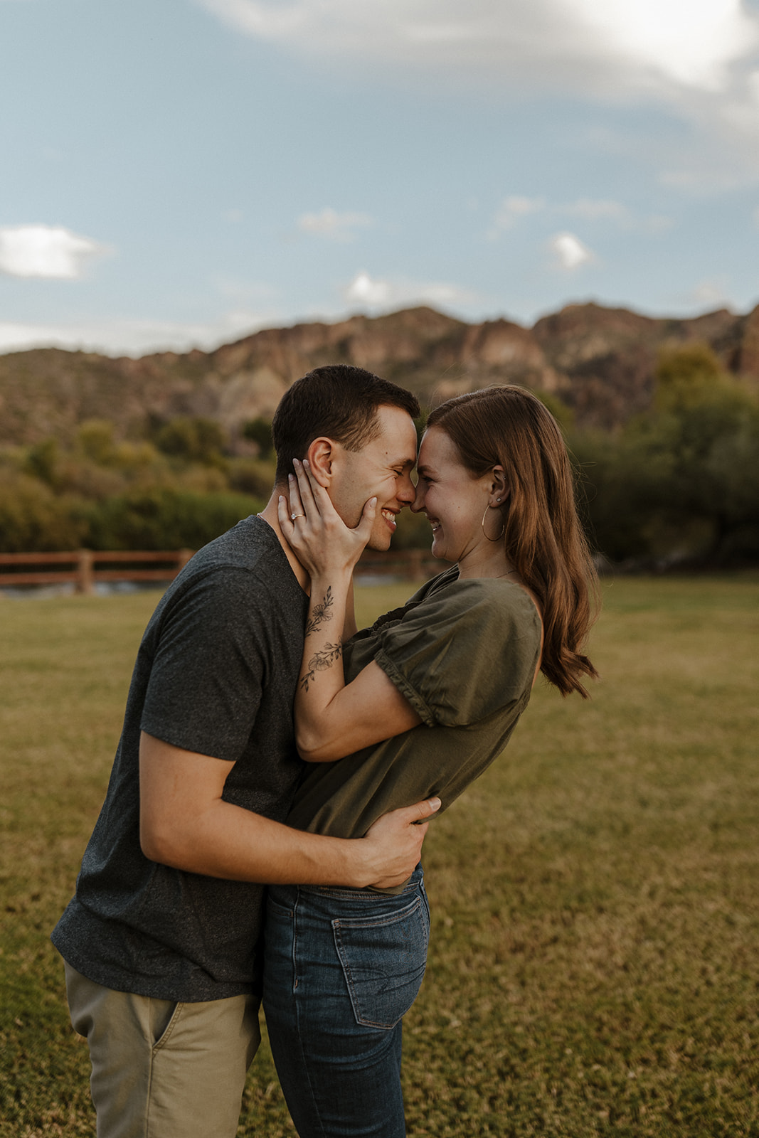 newly engaged couple putting their foreheads together and smiling at saguaro lake guest ranch Arizona 