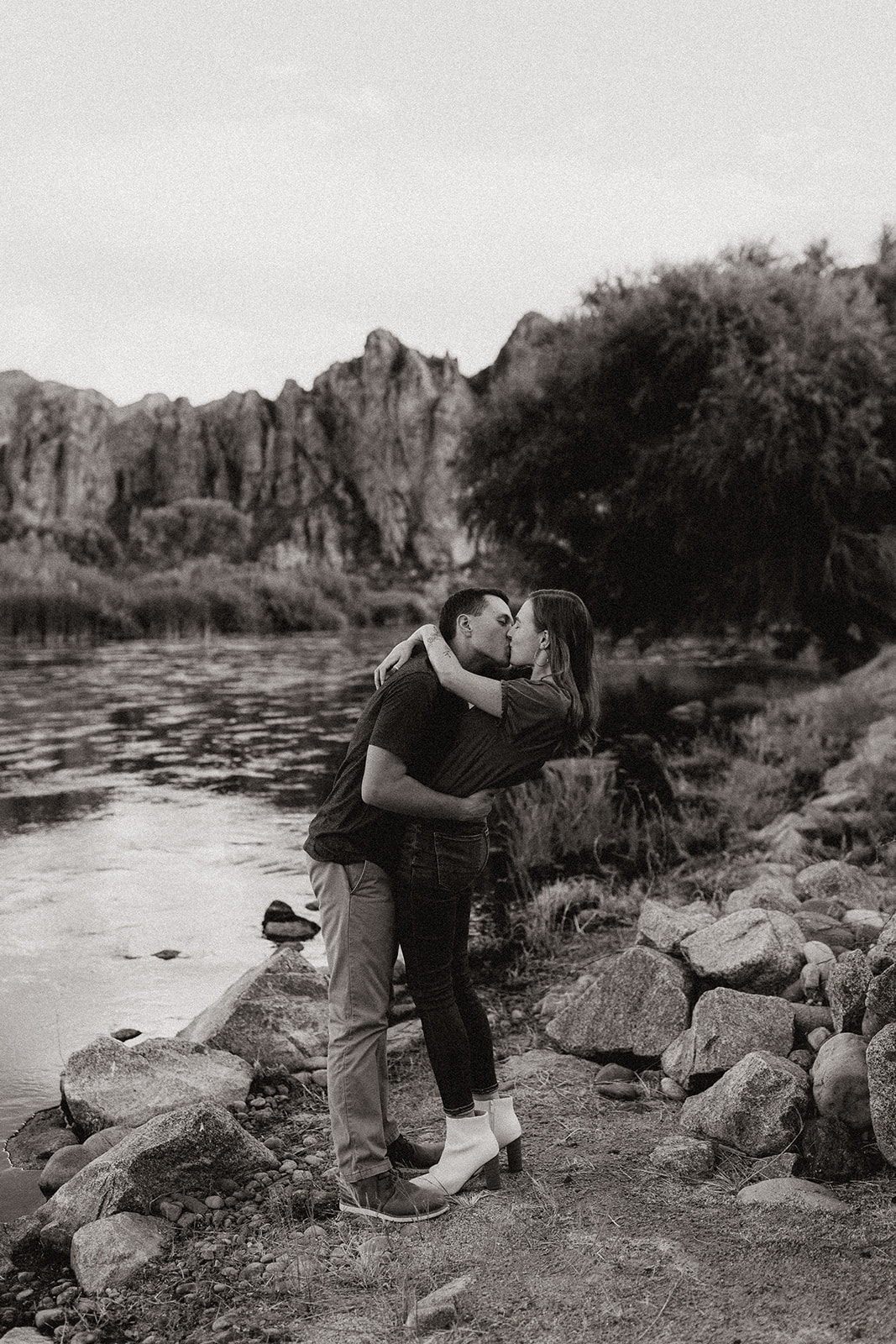 fiances kissing each other by the river at saguaro lake guest ranch Arizona 