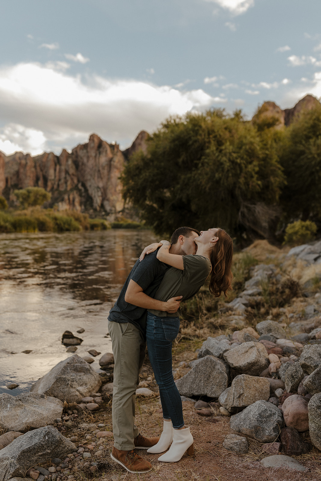 fiance kissing other fiances neck by the river at saguaro lake guest ranch Arizona 