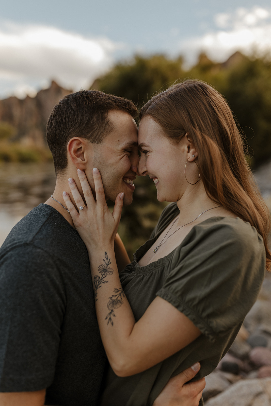 newly engaged couple putting foreheads and noses together at engagement session