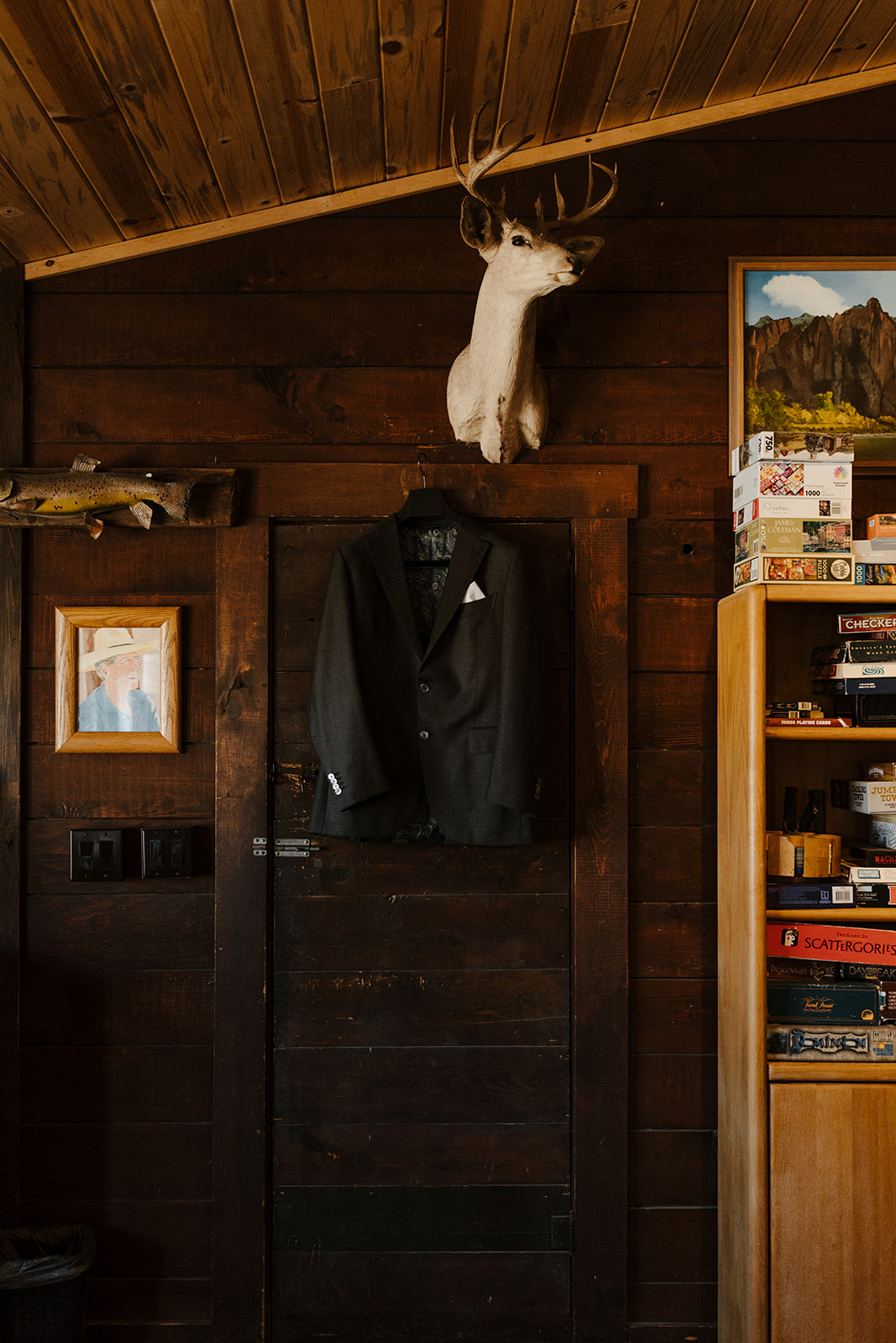 grooms tux hangin on cabin wall with a deer head above it at Saguaro Lake Guest Ranch Wedding