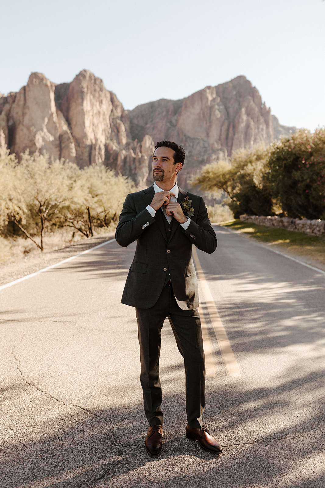 groom portrait standing on a road 