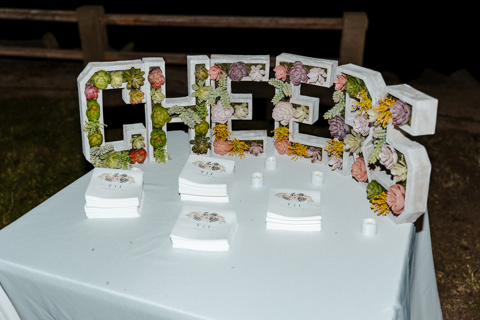 cheers sign with flowers inside the letters