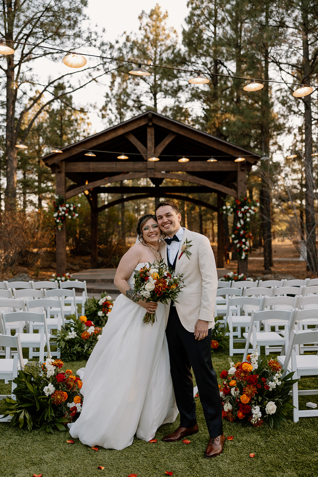 Stunning bride and groom pose together in front of their Arizona wedding venue