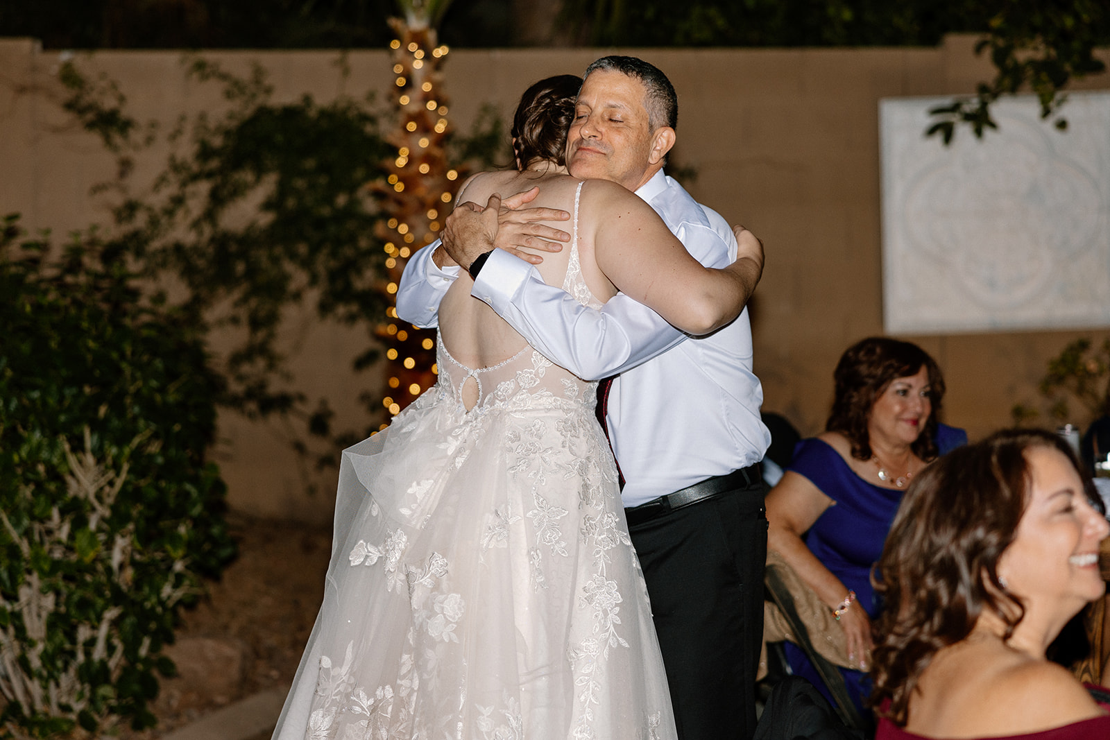 bride hugging guest at wedding reception