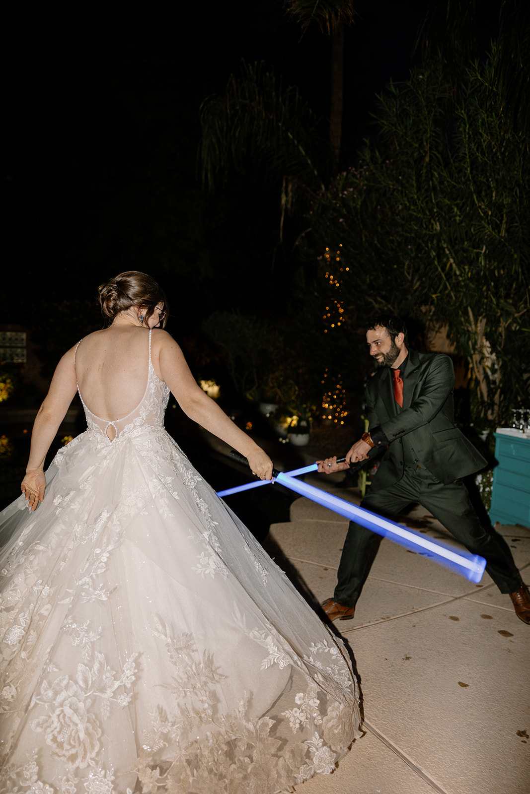 bride and groom with star wars lightsabers