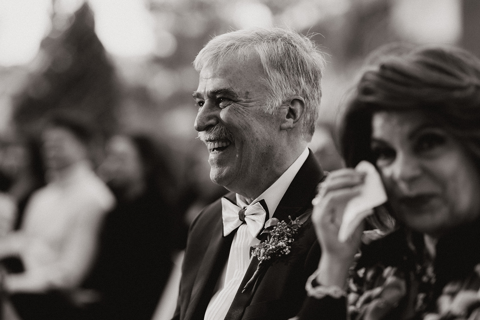 Brides dad smiles and laughs during his daughters dreamy wedding day