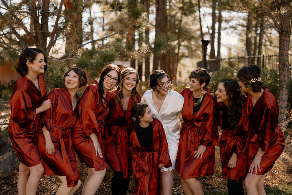 Bride poses with her bridesmaids as they prepare for the stunning Flagstaff wedding day