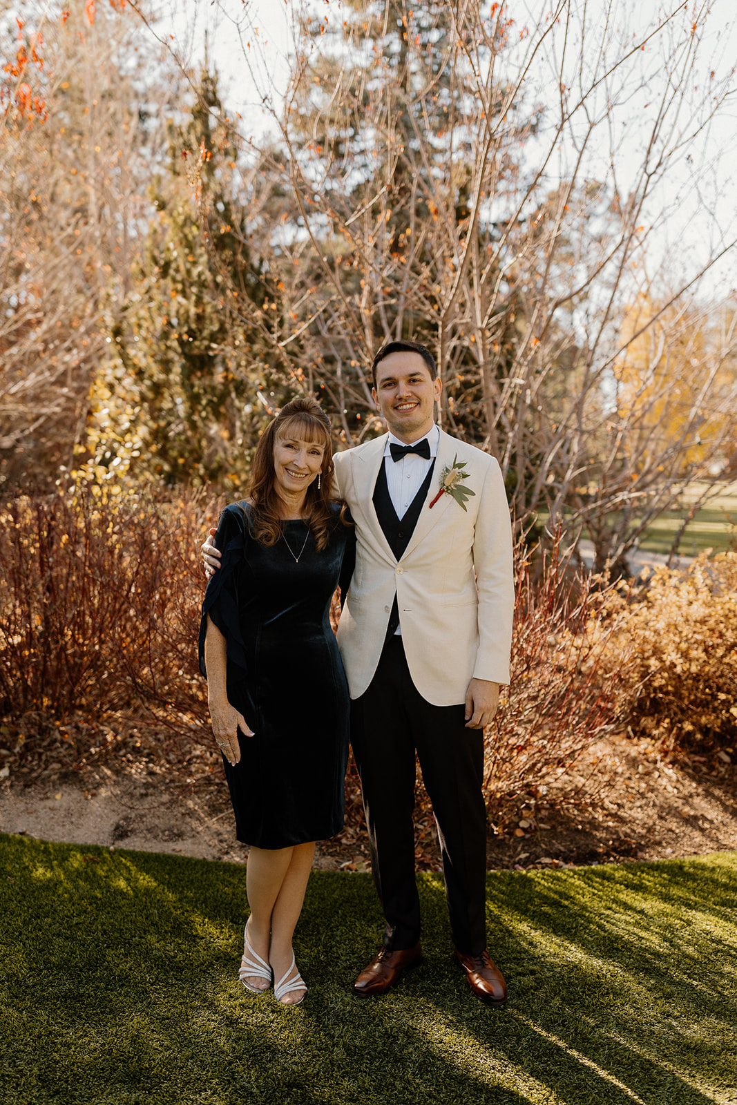 Groom poses with his proud mom before his wedding day