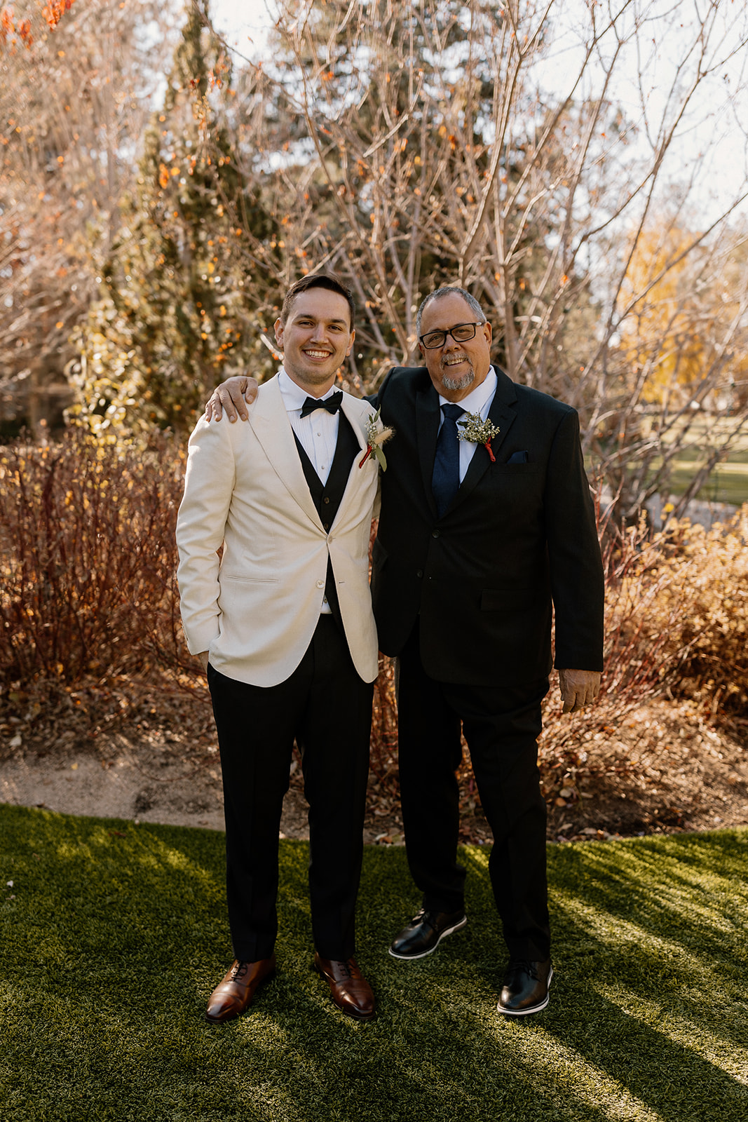 Groom poses with his proud father before his dreamy wedding day