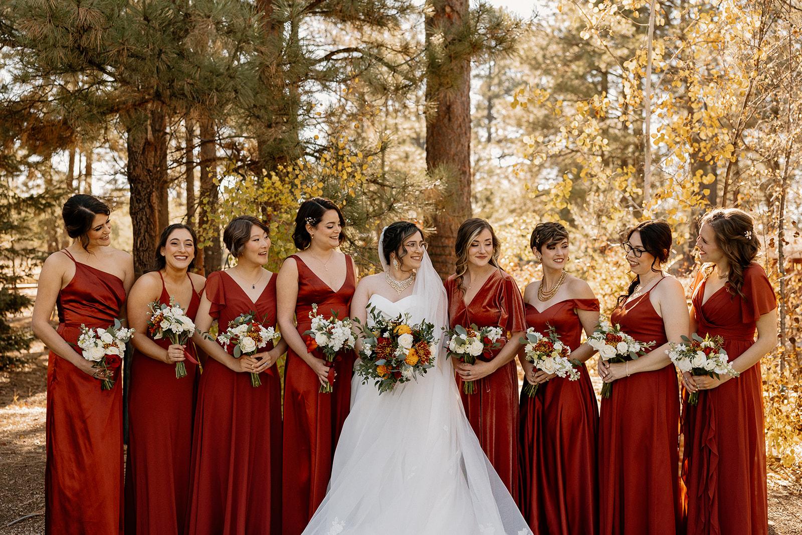 Bride poses with her bridesmaids as they prepare for the stunning Flagstaff wedding day