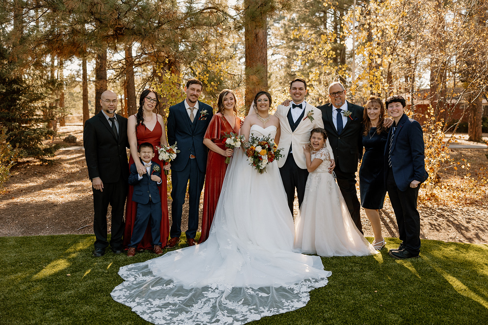 Bride and grooms families pose together after the dreamy Flagstaff wedding