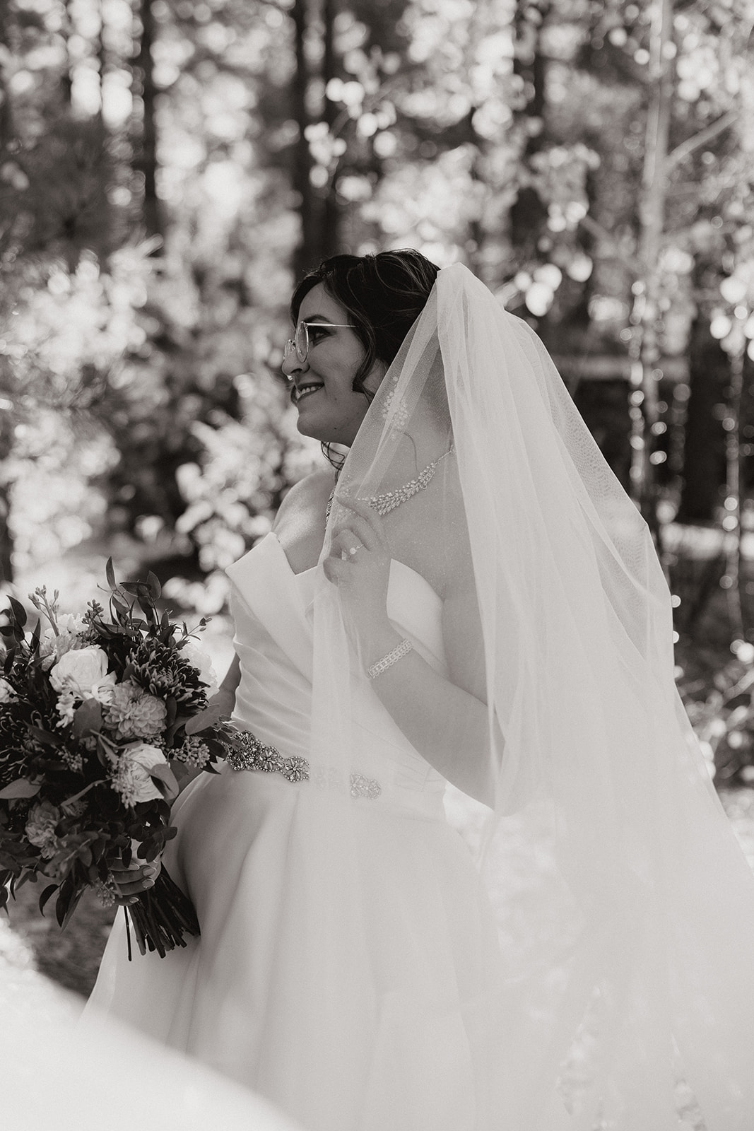Bride poses with her bouquet during her dreamy Flagstaff wedding
