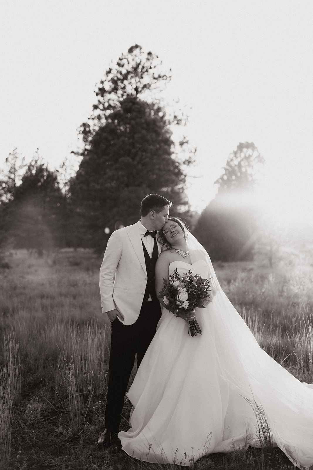 Stunning bride and groom pose together during golden hour after their dreamy Flag Staff, Arizona wedding