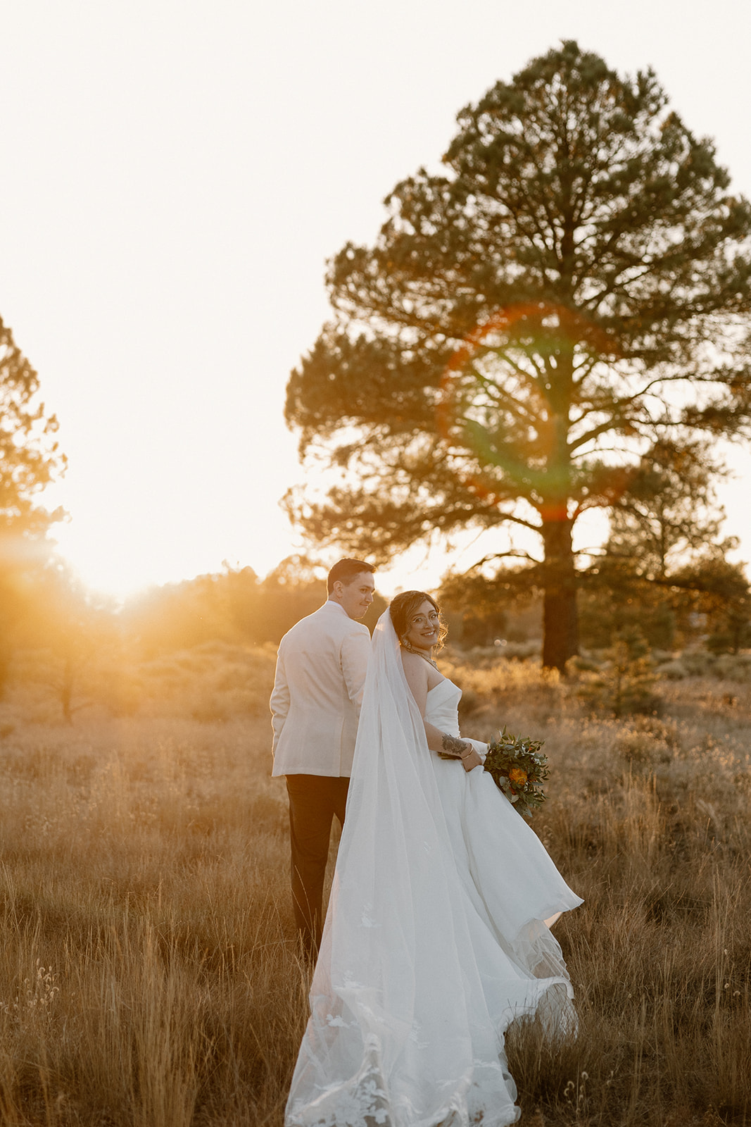 Stunning bride and groom pose together at golden hour after their dreamy Arizona wedding
