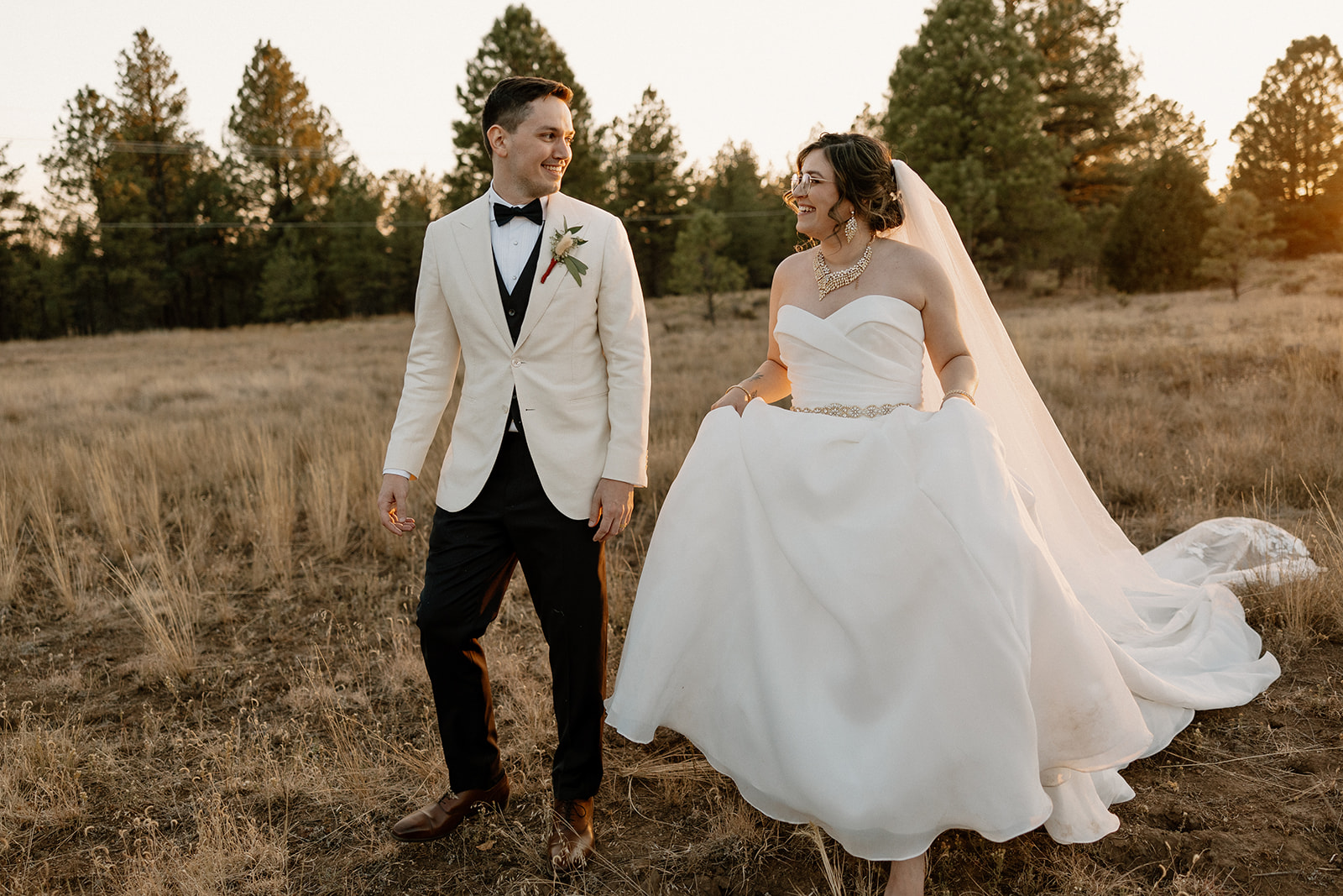 Stunning bride and groom pose together at golden hour after their dreamy Flag Staff, Arizona wedding