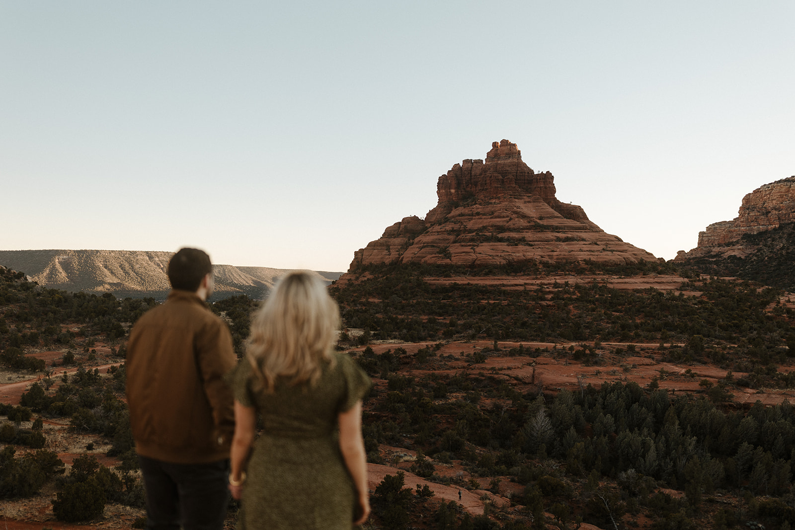 engaged couple blurry and sedona background in focus during engagement photos 