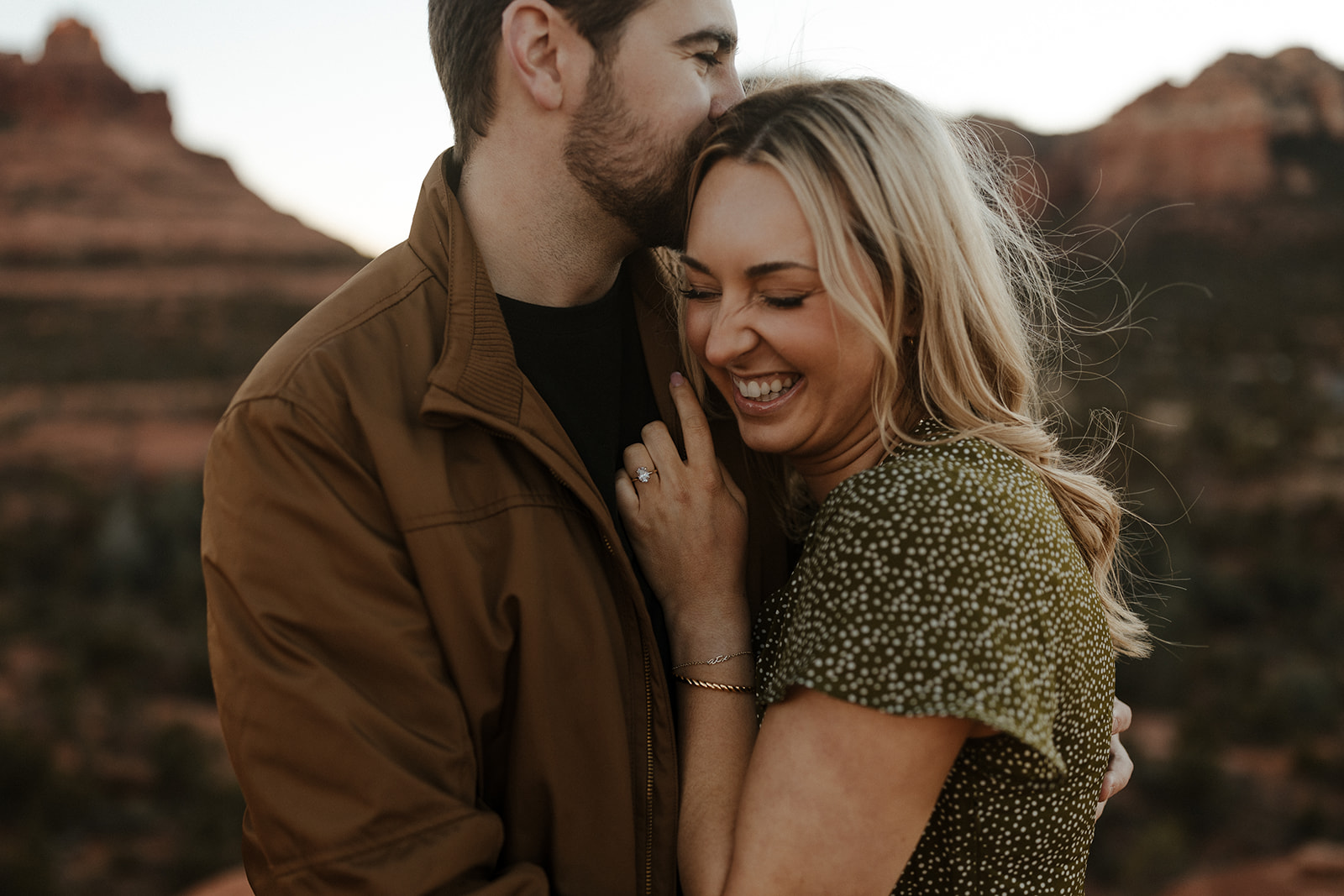 close up of engaged couple holding each other and smiling during sedona engagement photos