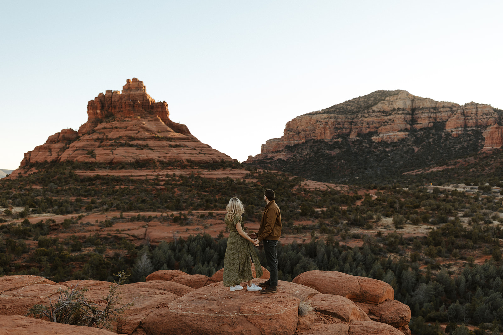engaged couple holding hands and taking in the view during sedona engagement photos