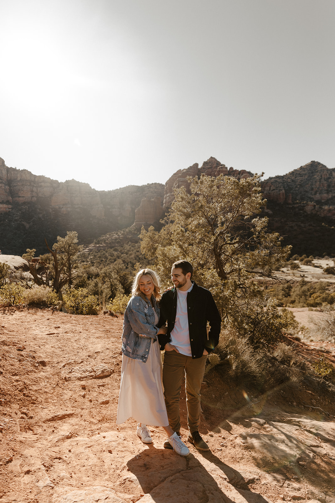 engaged couple holding each other and laughing in sedona 