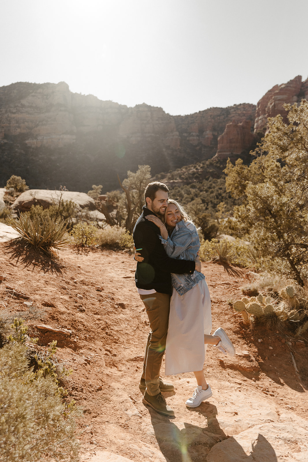 engaged couple hugging in the desert for sedona engagement photos